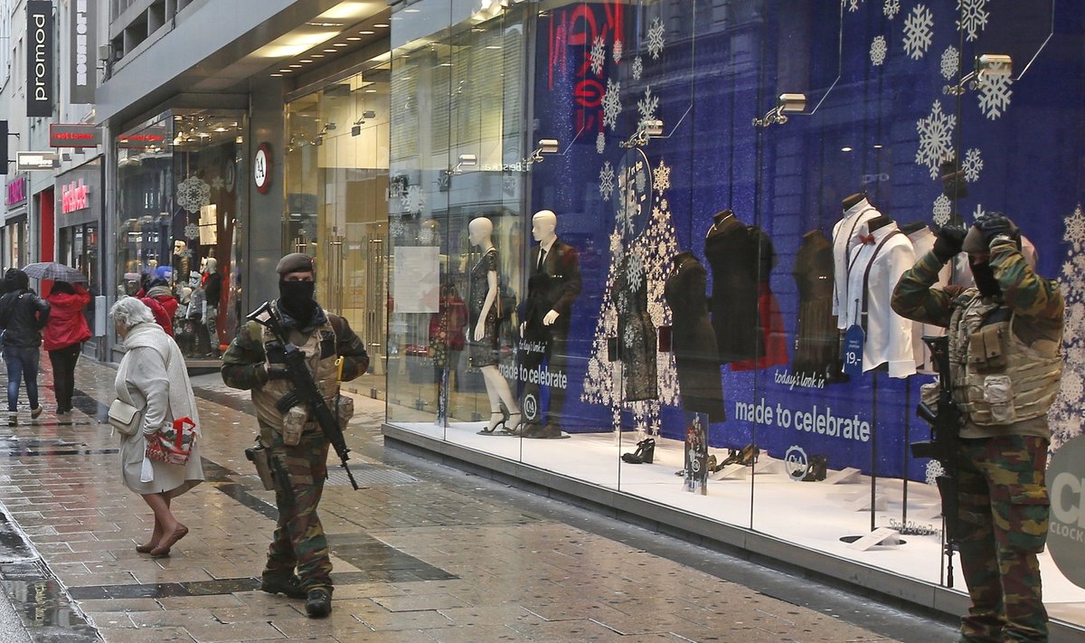 Belgian soldiers patrol a shopping street in central Brussels after security was tightened in Belgium following the fatal attacks in Paris