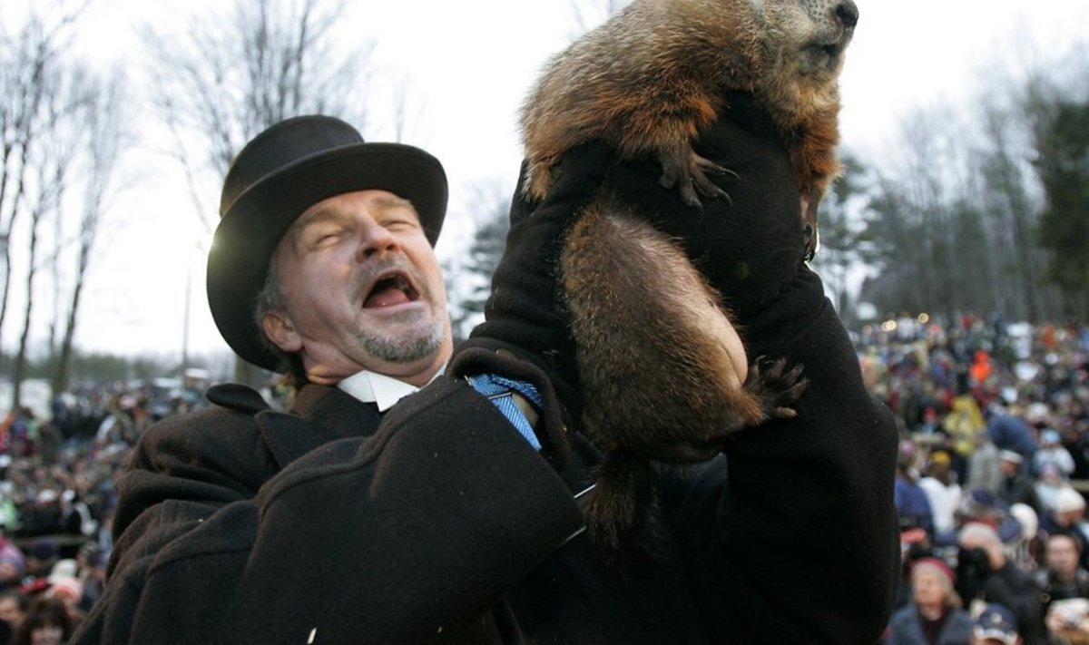 Groundhog Handler John Griffiths holds up weather prognosticating groundhog Punxsutawney Phil after his annual prediction on Gobbler's Knob in Punxsutawney, Pennsylvania, on the 123rd Groundhog Day, February 2, 2009. Phil saw his shadow, which means six more weeks of winter. REUTERS/Jason Cohn (UNITED STATES)