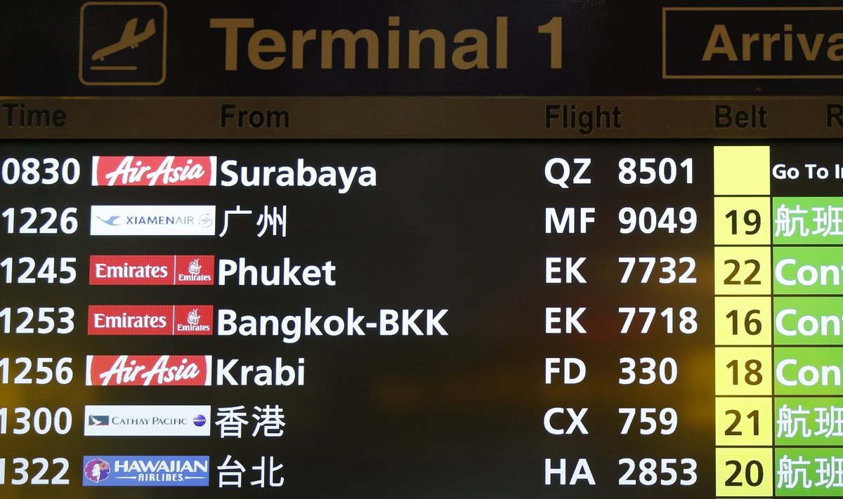 A flight information signboard shows the status of AirAsia flight QZ 8501 from the Indonesian city of Surabaya to Singapore at Changi Airport in Singapore