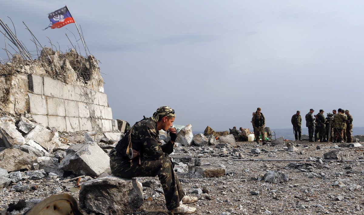 A Pro-Russian separatist sits at his position at Savur-Mohyla