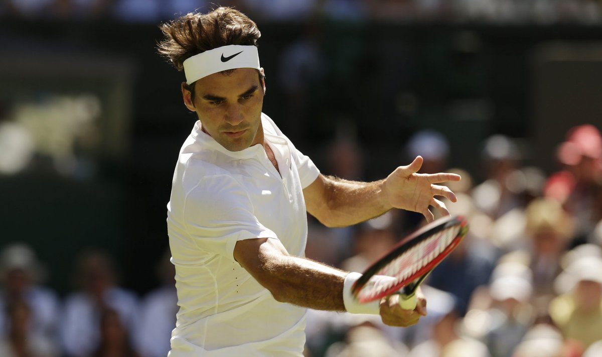 Roger Federer of Switzerland hits a shot during his match against Damir Dzumhur of Bosnia and Herzegovina at the Wimbledon Tennis Championships in London