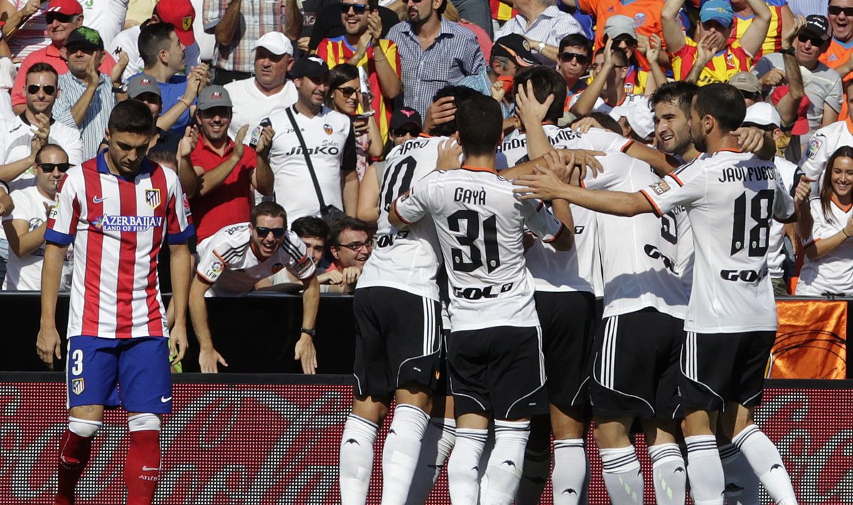 Valencia's players celebrate after they scored a goal against Atletico Madrid during their Spanish first division soccer match at the Mestalla stadium in Valencia