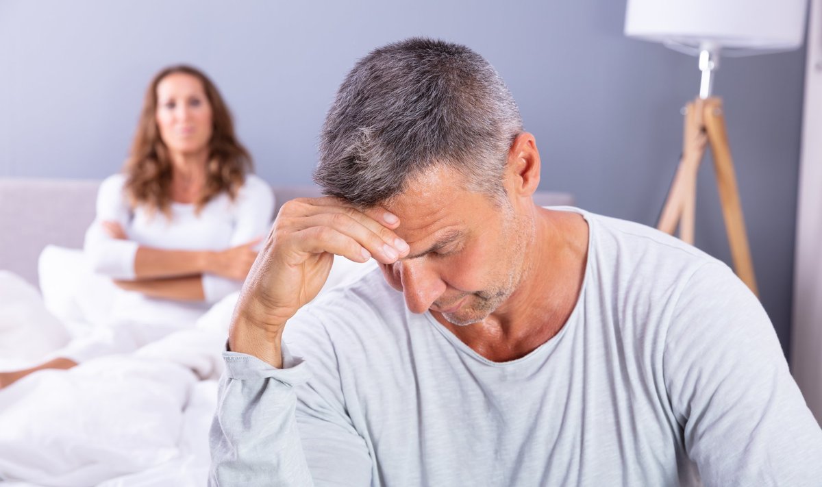 Close-up,Of,Depressed,Man,Sitting,On,Bed,In,Front,Of