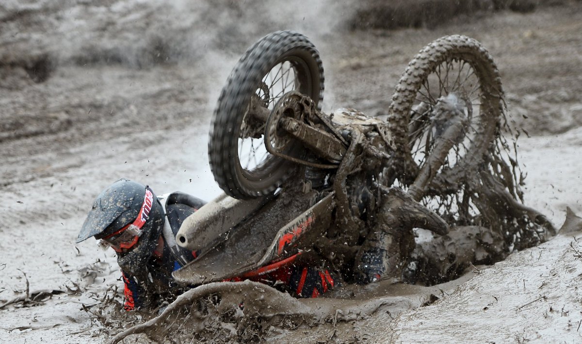 A rider crashes into the mud during the Gotland Grand National enduro race at Tofta, outside Visby on the island of Gotland, Sweden
