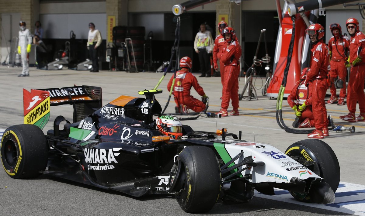 Force India Formula One driver Perez of Mexico drives his damaged car into the pits during the F1 United States Grand Prix at the Circuit of the Americas in Austin