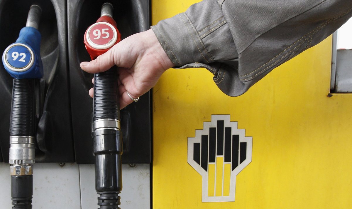 File photo of an attendant holding a gas pump at a Rosneft petrol station in St.Petersburg