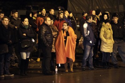 People gather near the collapsed Maxima supermarket in Riga
